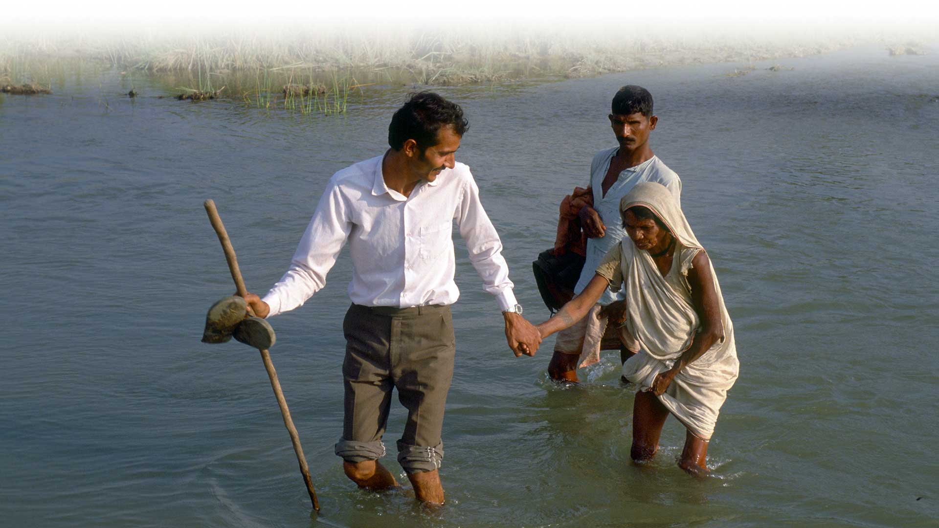 Photo of people crossing a river.