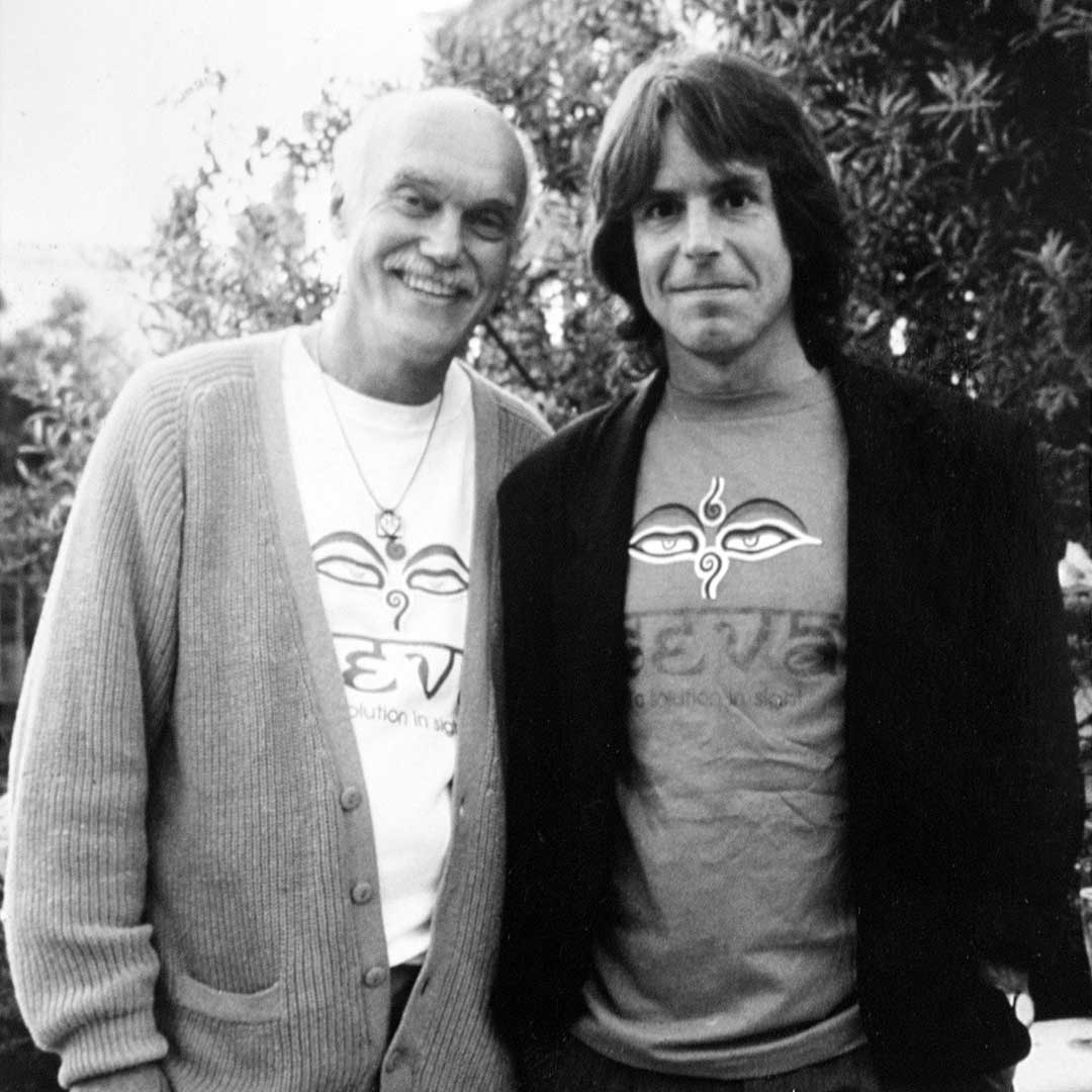 Ram Dass and Bob Weir wearing Seva shirts.